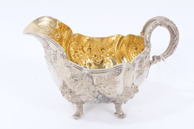 Lot 38 - Two Late 19th Century German Silver Sauce Boats of oval form, from the Royal Prussian Collection, with reeded border, repousse and chased with rocaille, flowers and foliage, with bifurcated foliage...