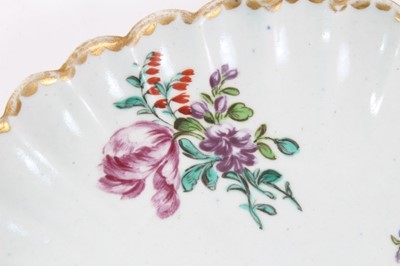 Lot 247 - Bow porcelain dish, c.1760, of fluted form, polychrome painted with flowers, 20cm diameter