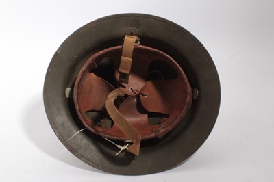 Lot 807 - American M1917A1 pattern steel helmet, with liner and chinstrap, with battle damage to exterior