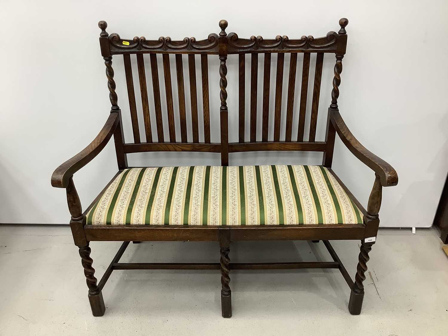 Lot 155 - 1920's oak rail back two seater bench with spiral twist supports