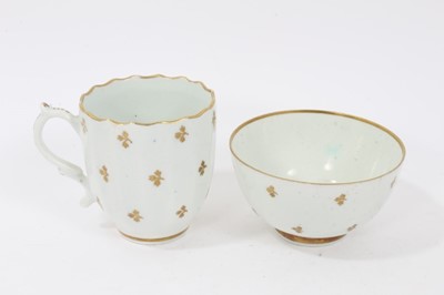 Lot 263 - Lowestoft sauceboat, of large moulded form, painted in blue with flower sprays highlighted in red enamel and gold, 21cm long, together with a Lowestoft coffee cup, of faceted form with scrolled han...