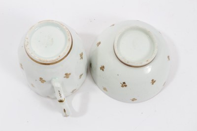 Lot 263 - Lowestoft sauceboat, of large moulded form, painted in blue with flower sprays highlighted in red enamel and gold, 21cm long, together with a Lowestoft coffee cup, of faceted form with scrolled han...