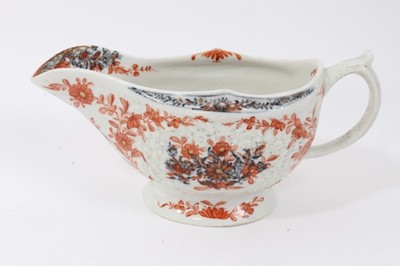 Lot 263 - Lowestoft sauceboat, of large moulded form, painted in blue with flower sprays highlighted in red enamel and gold, 21cm long, together with a Lowestoft coffee cup, of faceted form with scrolled han...