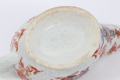 Lot 263 - Lowestoft sauceboat, of large moulded form, painted in blue with flower sprays highlighted in red enamel and gold, 21cm long, together with a Lowestoft coffee cup, of faceted form with scrolled han...