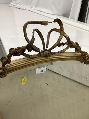 Lot 169 - Oval wall mirror in ornate gilt frame with ribbon and swag decoration, 100cm x 77cm