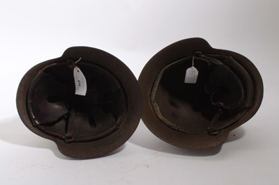 Lot 924 - Spanish M26 steel helmet as worn by Nationalist / Fascist forces during the Spanish Civil War, with painted Facist symbols to exterior, together with another Spanish M26 steel helmet (2)