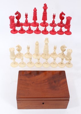 Lot 956 - 19th century, turned white and red stained ivory chess set of monobloc form with screw on bases, the Kings, of tapering design, surmounted by a Maltese cross, in a mahogany case. Possibly English,...