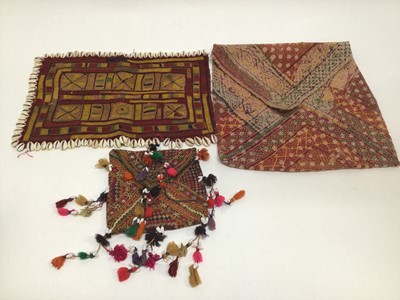 Lot 1946 - Selection of vintage fabric including African Banjari squares with Cowrie shells, embroidered bag with shels, mirror work and tassels, large embroidered cotton pouch, Indian mettalic thread roundal...