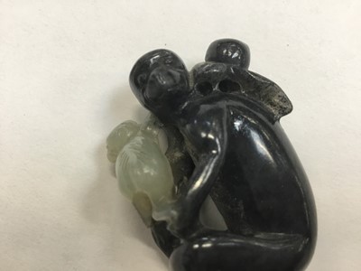 Lot 943 - Chinese jade or green hardstone carving, depicting a family of monkeys, utilising the colours in the stone, 3cm high, together with a pair of jade or green hardstone figures of reclining buffalo an...