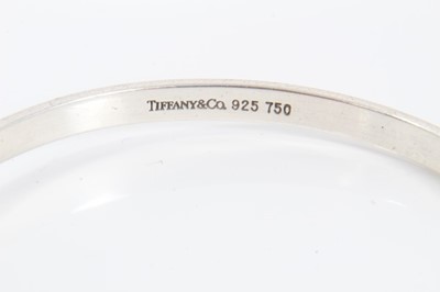 Lot 149 - Tiffany & Co. silver bangle with hook and eye fitting and 18ct gold mounts. London, 1959