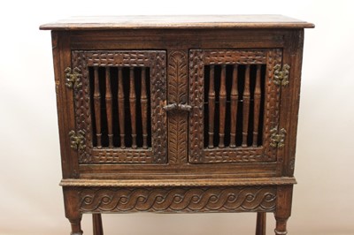 Lot 1444 - Antique oak food hutch enclosed by a pair of bared doors, on carved frieze and fluted turned supports united by stretchers, early elements probably with alterations, 80cm wide x 40cm deep x 121cm h...