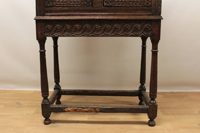 Lot 1444 - Antique oak food hutch enclosed by a pair of bared doors, on carved frieze and fluted turned supports united by stretchers, early elements probably with alterations, 80cm wide x 40cm deep x 121cm h...