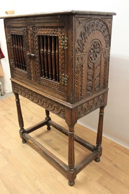 Lot 1444 - Antique oak food hutch enclosed by a pair of bared doors, on carved frieze and fluted turned supports united by stretchers, early elements probably with alterations, 80cm wide x 40cm deep x 121cm h...