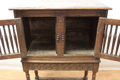 Lot 1444 - Antique oak food hutch enclosed by a pair of bared doors, on carved frieze and fluted turned supports united by stretchers, early elements probably with alterations, 80cm wide x 40cm deep x 121cm h...