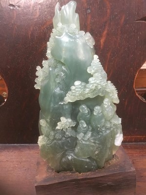 Lot 313 - A carved jade on green hardstone mountain scene with Buddhas