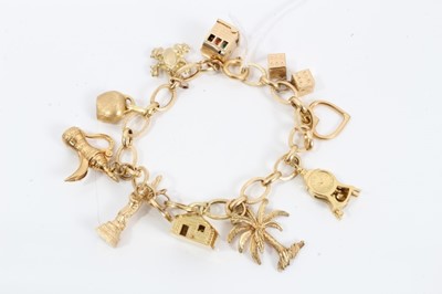 Lot 164 - Gold charm bracelet with ten various gold charms