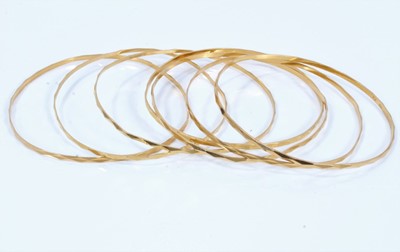 Lot 165 - Seven 18ct gold faceted bangles