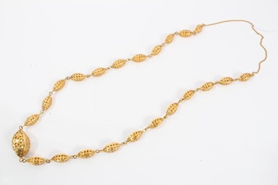 Lot 166 - Gold pierced bead necklace