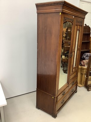 Lot 173 - Late Victorian walnut double wardrobe enclosed by one bevelled mirror door and one glazed and panelled door, with two short and one long drawer below, 132cm wide x 54cm deep x 209cm high
