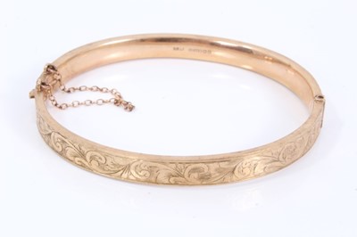Lot 172 - 9ct gold bangle with engraved scroll decoration