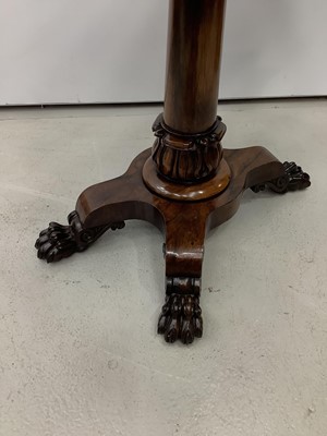 Lot 180 - 19th century rosewood card table with foldover revolving top on turned column and quatrefoil base with carved paw feet, 92cm wide x 74.5cm high