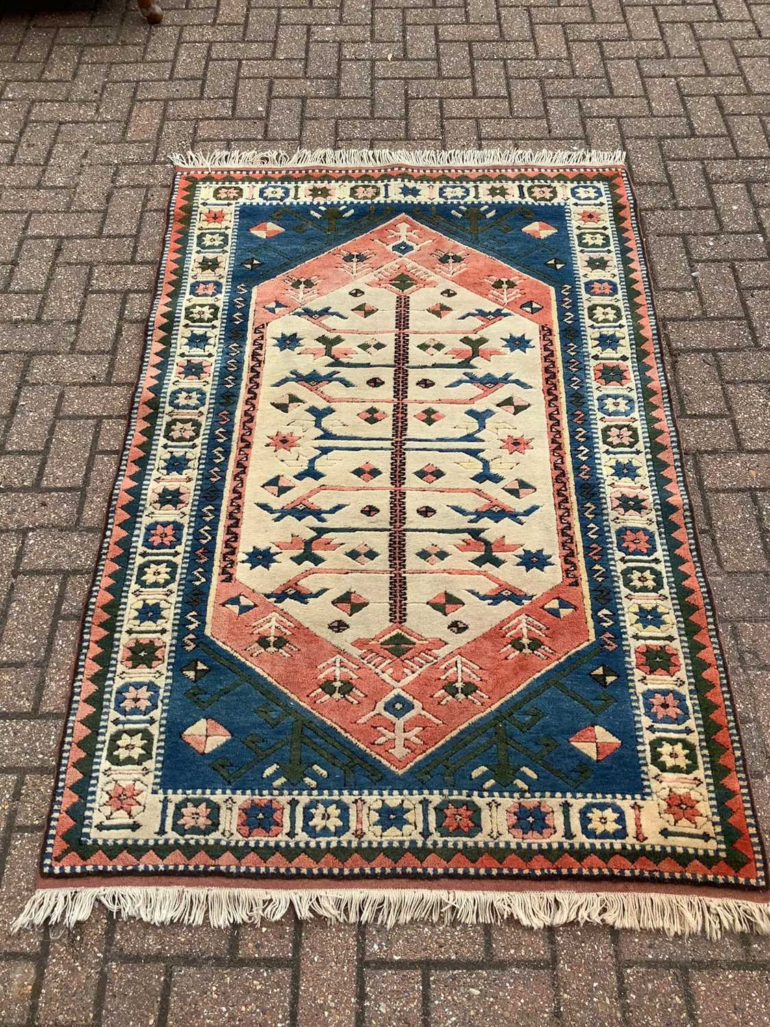 Lot 186 - Eastern rug with geometric decoration on red, blue, greem and cream ground, 188cm x 123cm