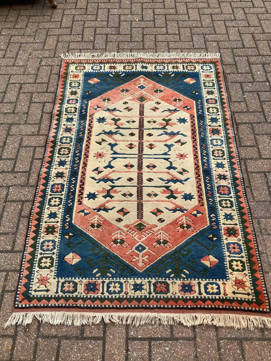 Eastern Rug Designs Lot 186 - Eastern rug with geometric decoration on red,