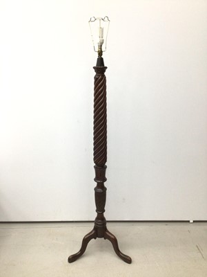 Lot 184 - Three various mahogany standard lamps with spiral columns, two on tripod bases