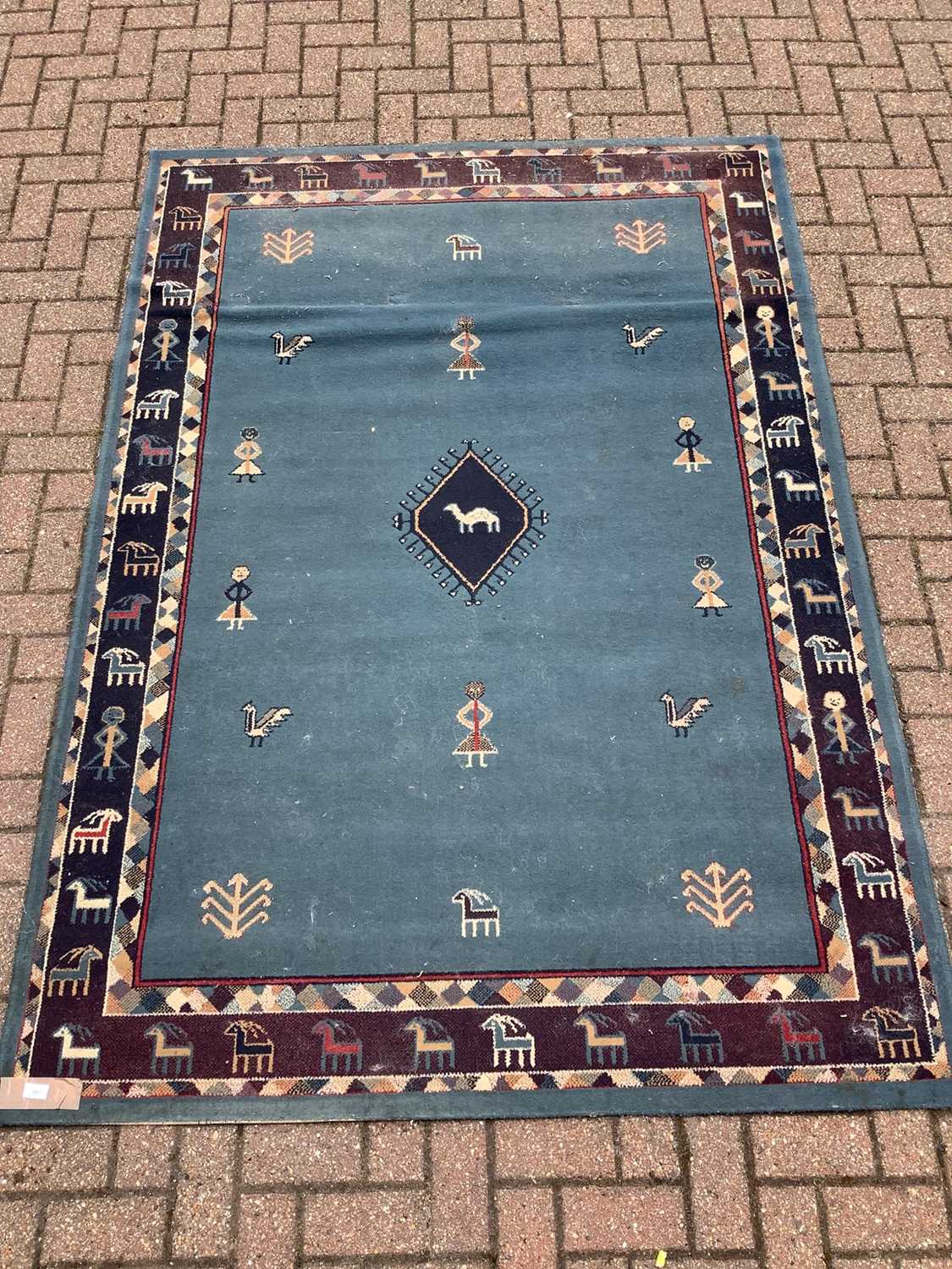 Lot 187 - Old rug decorated with figures and animals on blue ground  228cm x 160cm