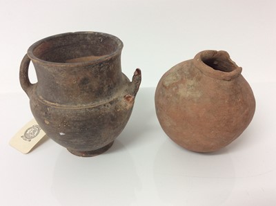 Lot 994 - Small ancient twin handled black glazed amphora, middle Bronze Age, together with a small Romano-Egyptian globular flask