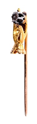 Lot 654 - 19th century gold and diamond novelty stick pin in the form of a hand holding a rose cut diamond, the hand measuring approximately 14mm, the overall length approximately 33mm.