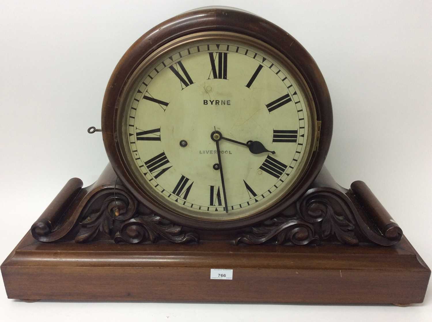 Lot 766 - Large Victorian boardroom clock retailed by Byrne, Liverpool with painted dial, Winterhauser& Huffmeyer 8 day movement with Westminster chimes and gongs with repeat action, scroll carved decoration...