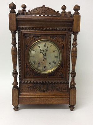 Lot 767 - Late 19th century Continental musical bracket clock with silvered dial, the movement with 8 bells and gong in carved oak case on turned bun feet 55.5 cm high