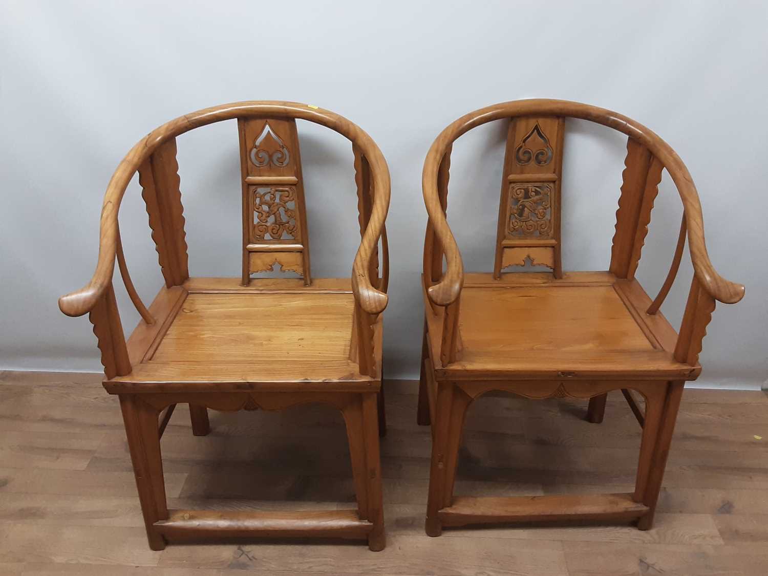 Lot 1540 - Pair of Chinese elm horseshoe chairs