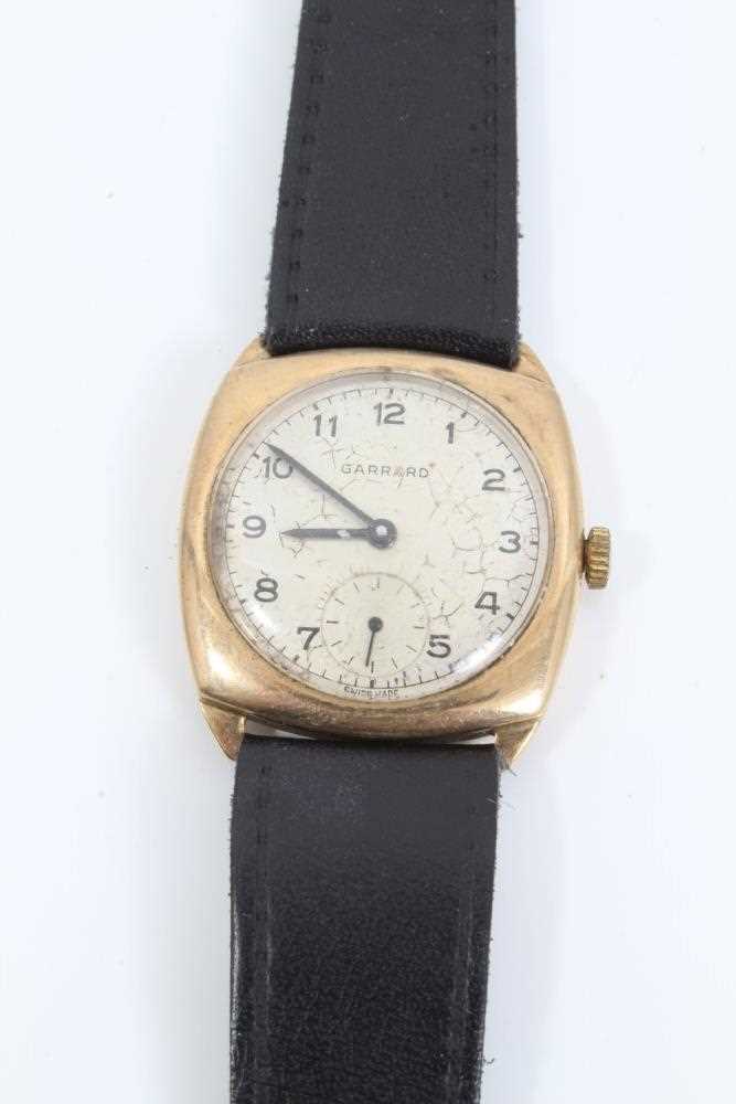 Lot 210 - 9ct gold vintage Garrard wristwatch on black leather strap