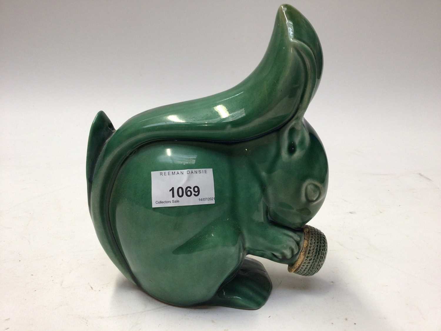 Lot 1069 - Rare 1930s Denby Velray green glazed squirrel with stopper