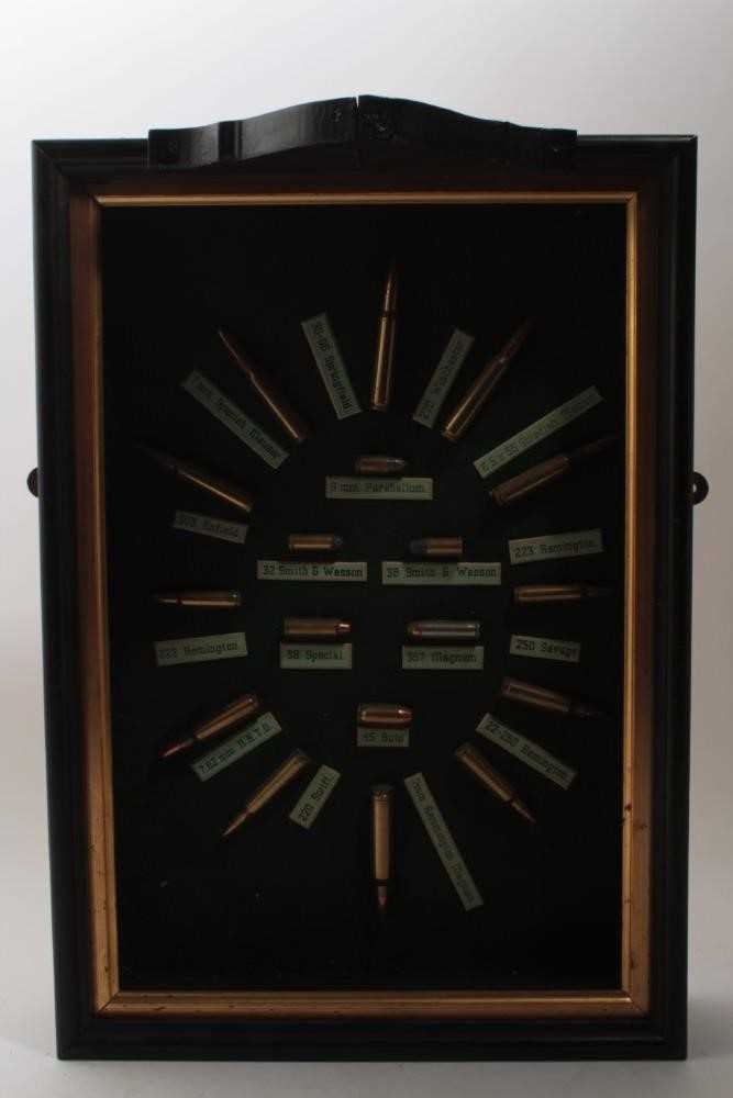 Lot 999 - Interesting display of various bullet casings, with annotations, mounted in a wooden frame, 48 x 34cm