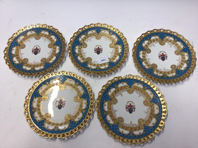 Lot 1091 - Set of five 19th century Armorial plates with blue and gilt decoration and pierced gilt rims, 23cm diameter