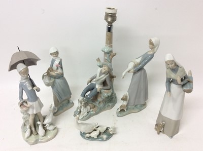 Lot 1097 - Two Lladro porcelain figures of ladies with animals, and four other Lladro or Nao porcelain ornaments including a lamp base (6)