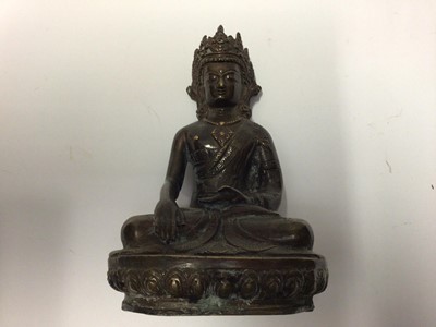 Lot 2201 - Tibetan bronze Buddha, shown seated cross-legged on a lotus base, 20.5cm high, together with a further object, possibly a Tibetan hanging incense holder (2)