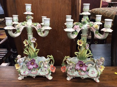 Lot 488 - Pair of early 20th century German porcelain candelabra mounted with cherubs