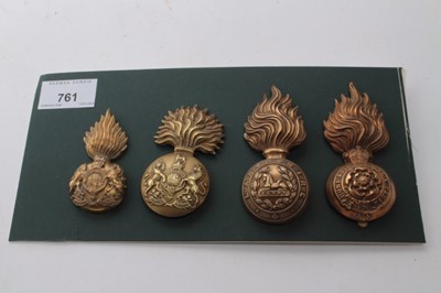 Lot 761 - Four First World War Brass Fusiliers Grenade badges, on card backing