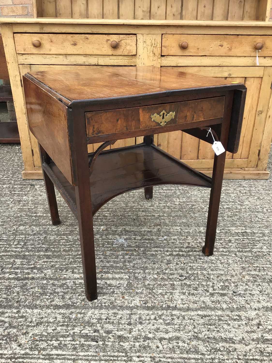 Lot 860 - Georgian mahogany two tier side table, the single drawer flanked by twin drop flaps and a single shaped tier below, alterations