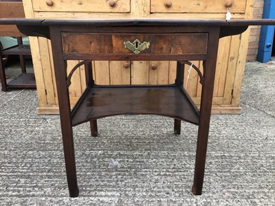 Lot 916 - Georgian mahogany two tier side table, the single drawer flanked by twin drop flaps and a single shaped tier below, alterations