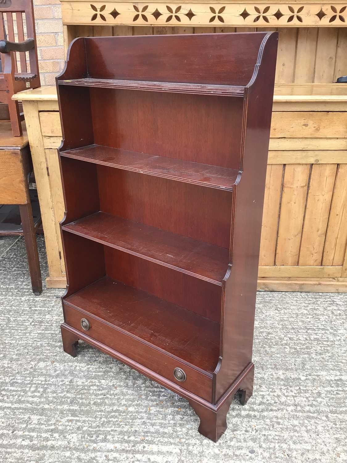 Lot 918 - Reproduction mahogany waterfall front open bookcase with single drawer, on bracket feet