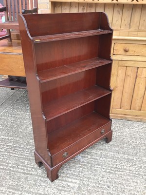 Lot 918 - Reproduction mahogany waterfall front open bookcase with single drawer, on bracket feet