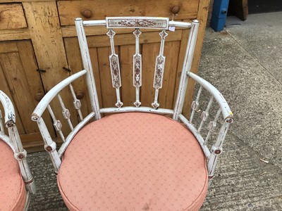 Lot 919 - Pair of painted open elbow chairs with decorative shaped backs, caned seats with cushions, on shaped legs joined by stretchers