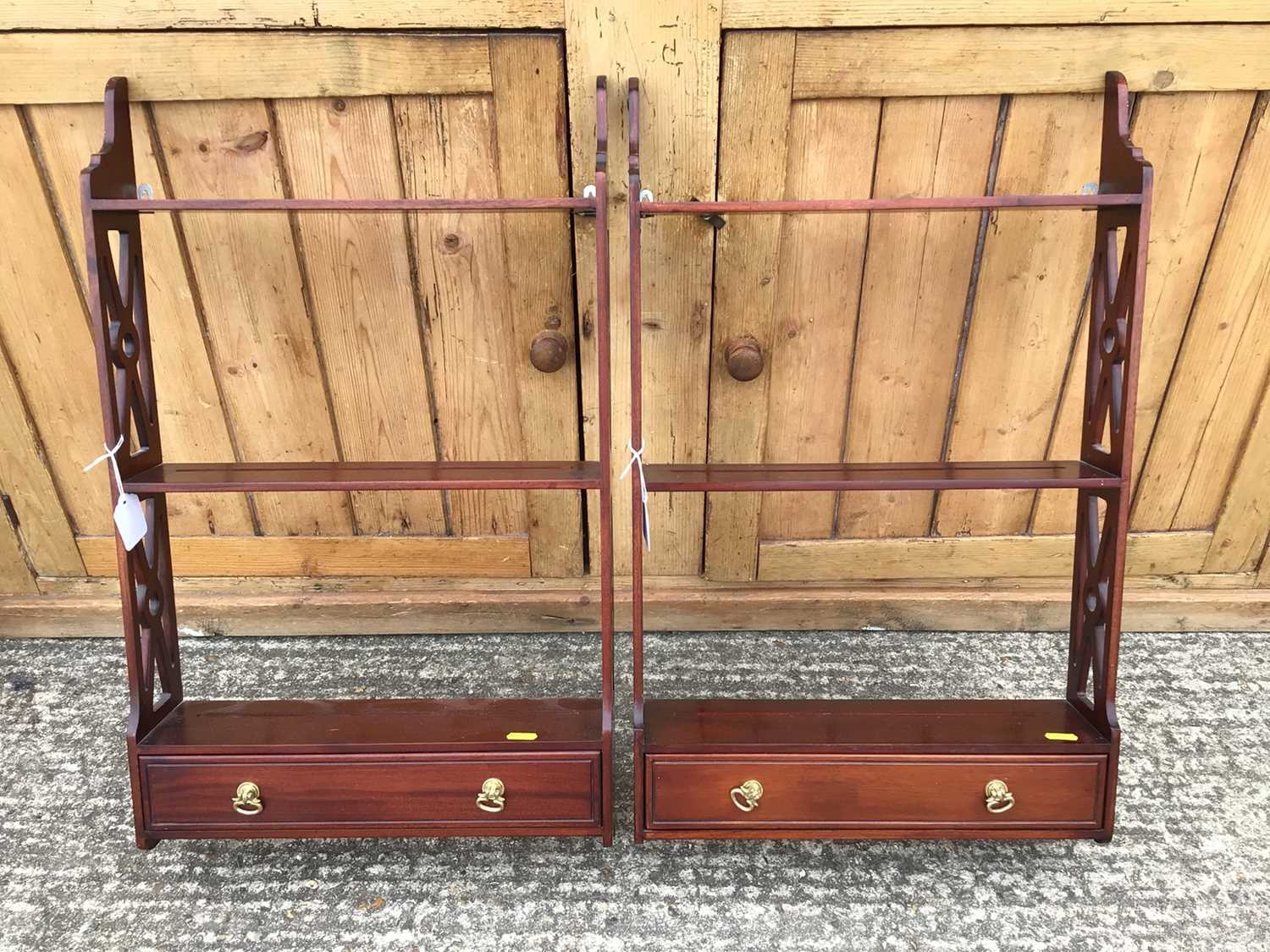 Lot 920 - Pair of reproduction open hanging shelves, each with pierced sides and single drawer