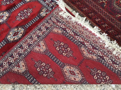 Lot 930 - Two Eastern rugs with geometric decoration on red ground 160x104cm, 156x89cm