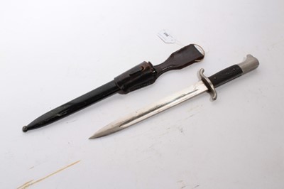 Lot 965 - Second World War Nazi Fire brigade dress Bayonet with black checkered plastic grip and polished steel blade (retaining almost all original finish), stamped Solingen, in black painted steel scabbard...